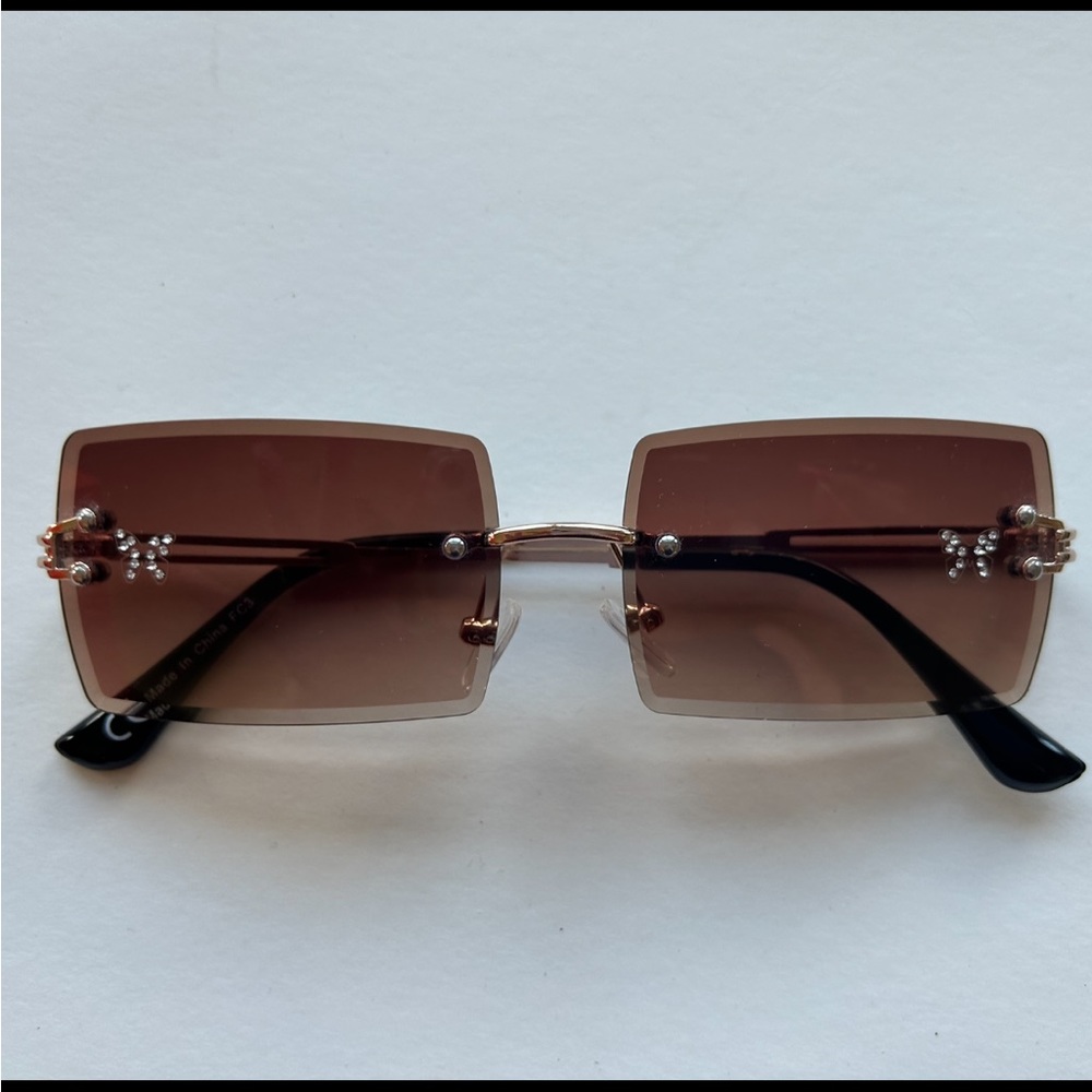 Ocean Beach Women’s Sunglasses with butterfly graphic on each lense.